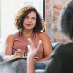 Business owner taking notes in a one-on-one meeting