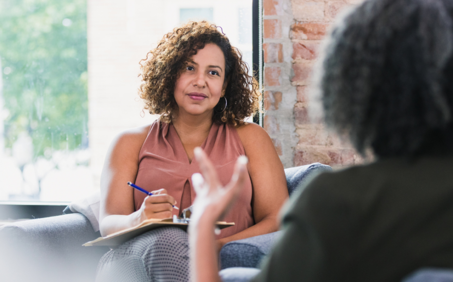 Business owner taking notes in a one-on-one meeting