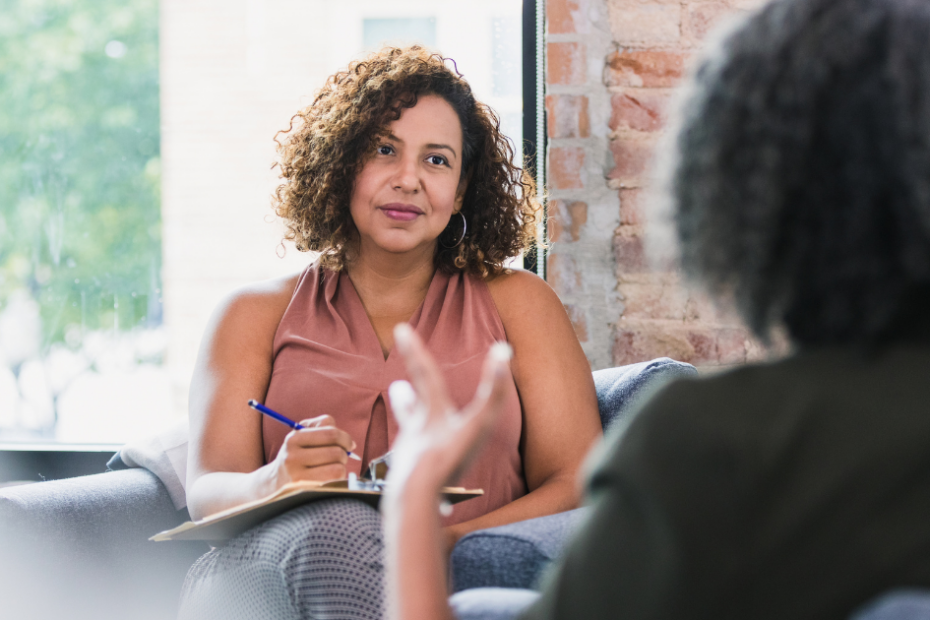 Business owner taking notes in a one-on-one meeting