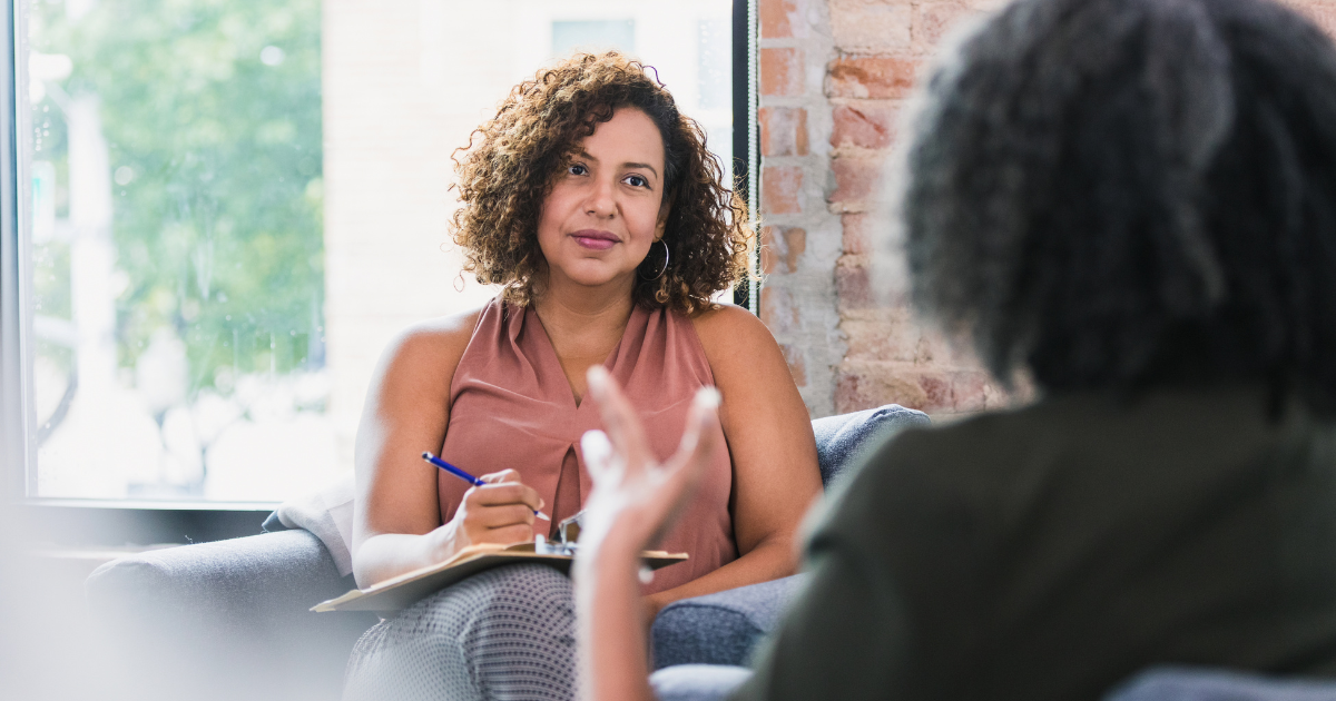 Business owner taking notes in a one-on-one meeting