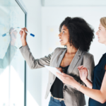 Business owners writing on a white board