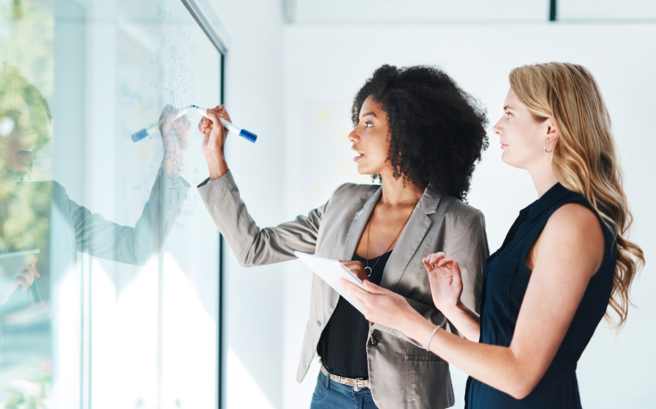 Business owners writing on a white board