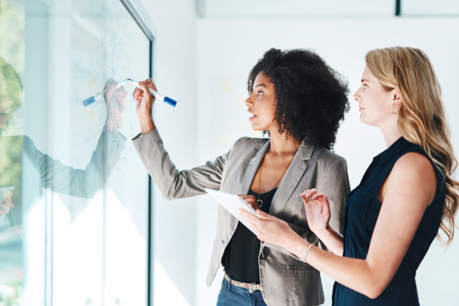 Business owners writing on a white board