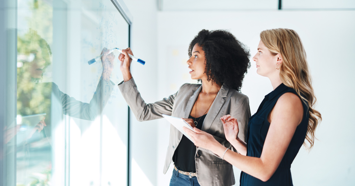 Business owners writing on a white board