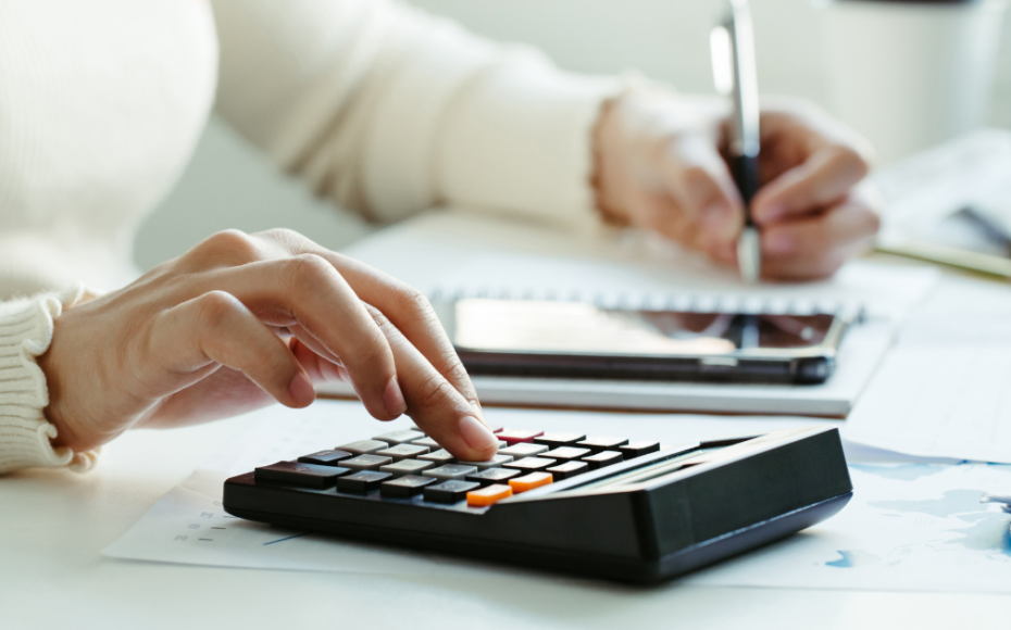 Person typing on a calculator