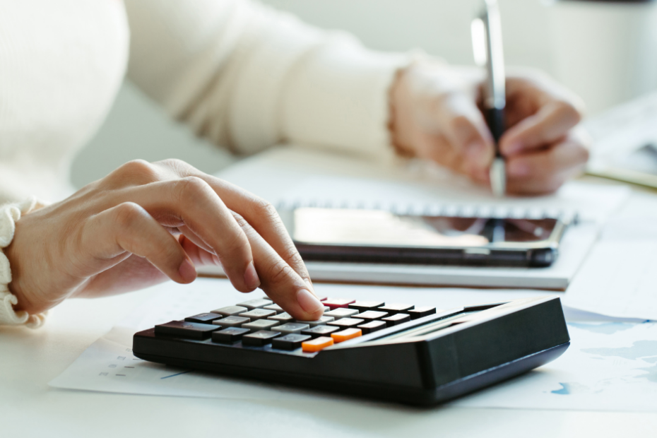 Person typing on a calculator