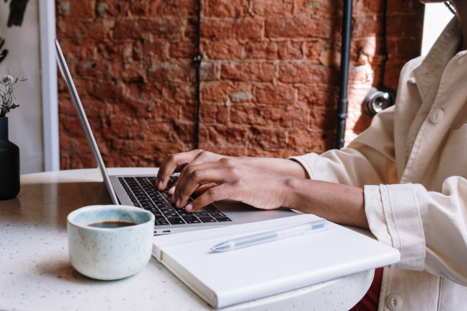 Person working on laptop at a cafe