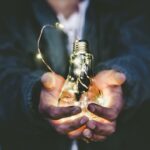 worker holding light bulb