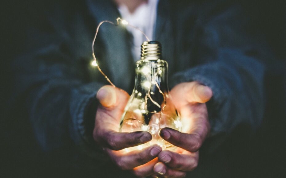 worker holding light bulb