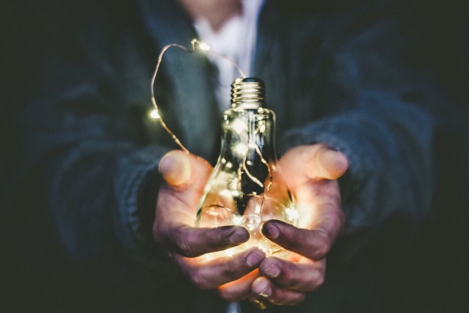 worker holding light bulb