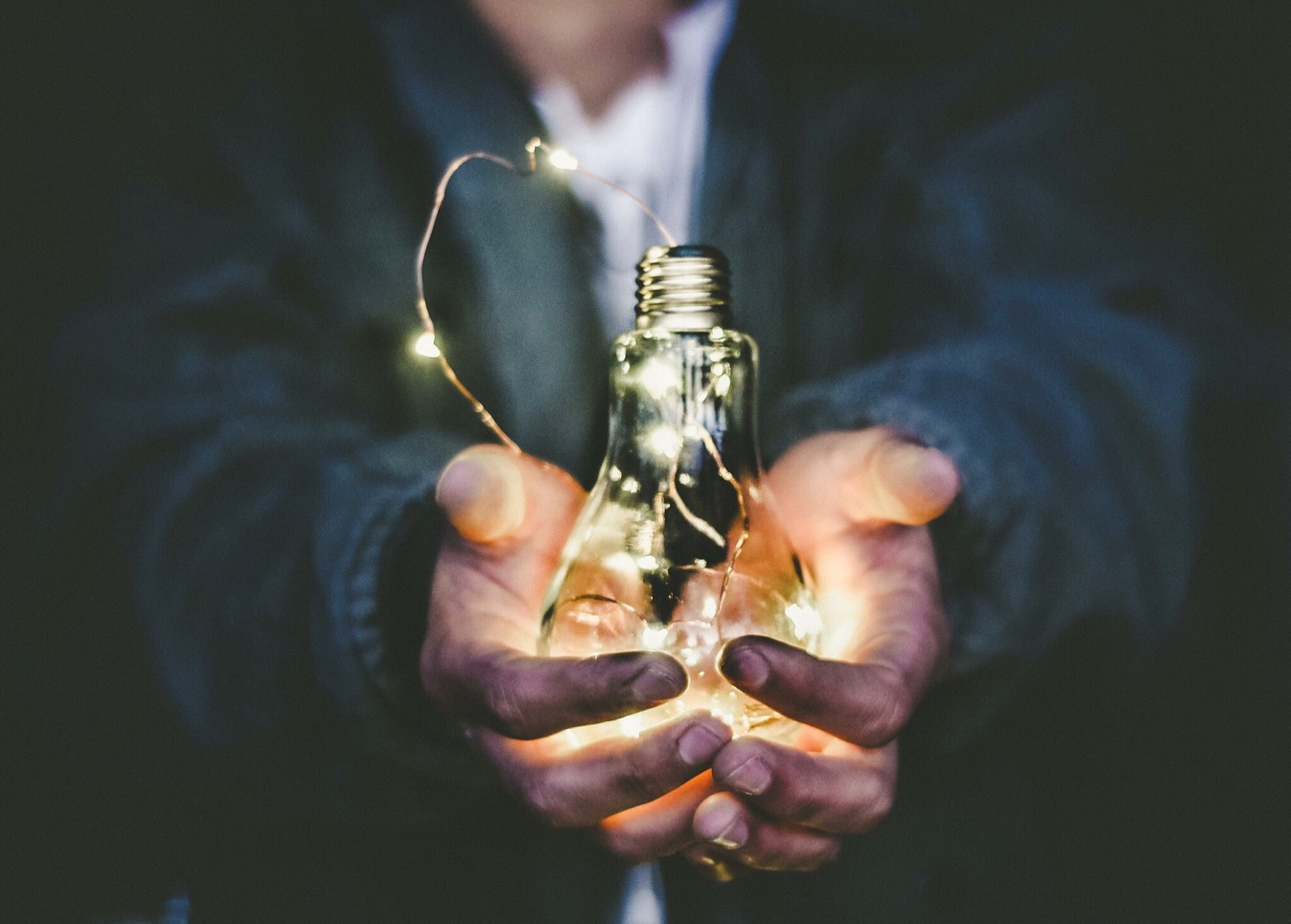 worker holding light bulb