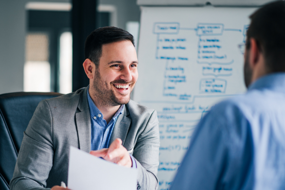 Happy business owner in front of white board