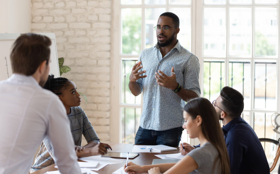 Business owner standing at a work meeting