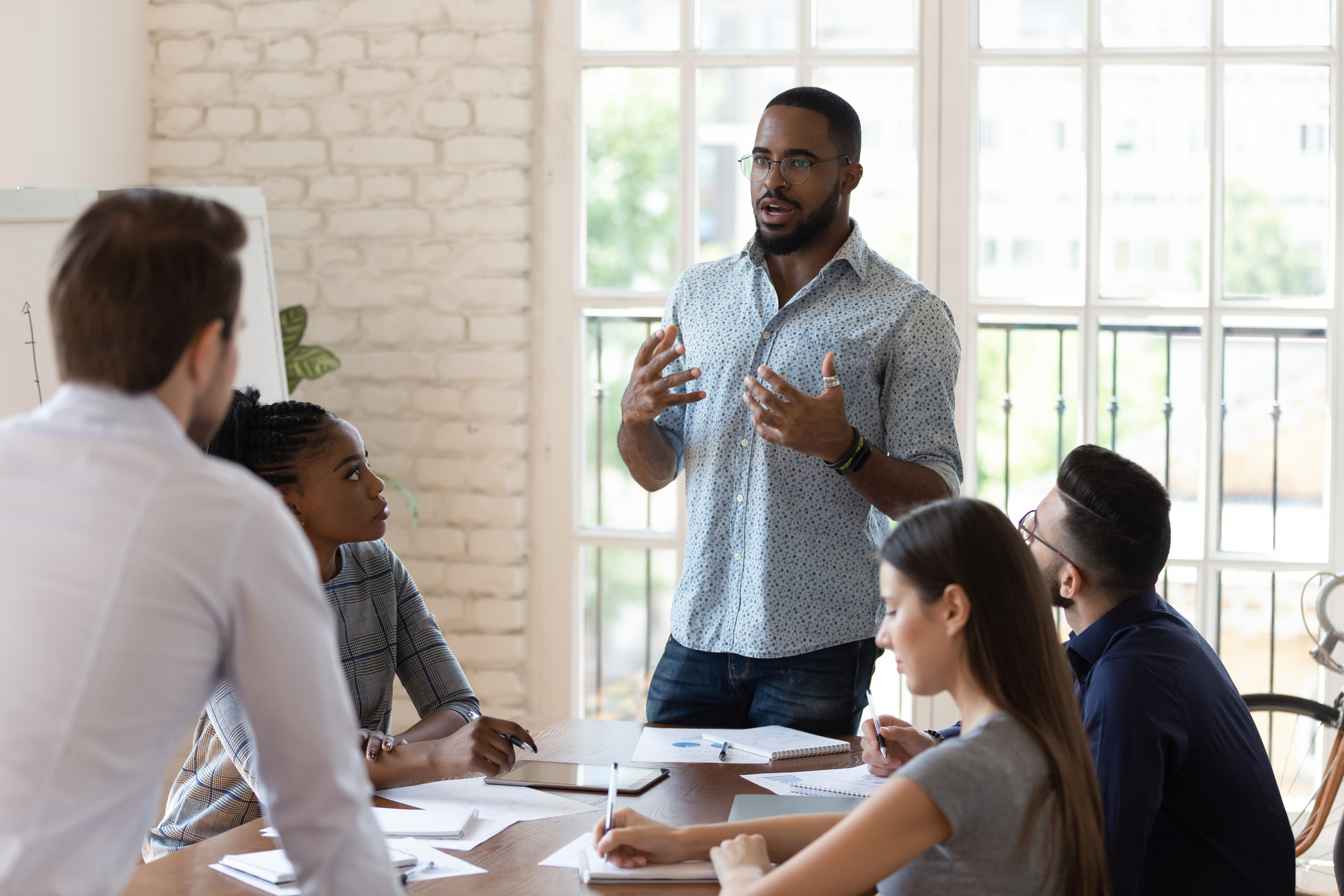 Business owner standing at a work meeting