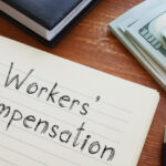 Workers' Compensation written on notepad on desk