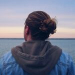 Person looking out onto a lake