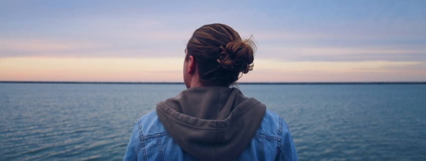 Person looking out onto a lake