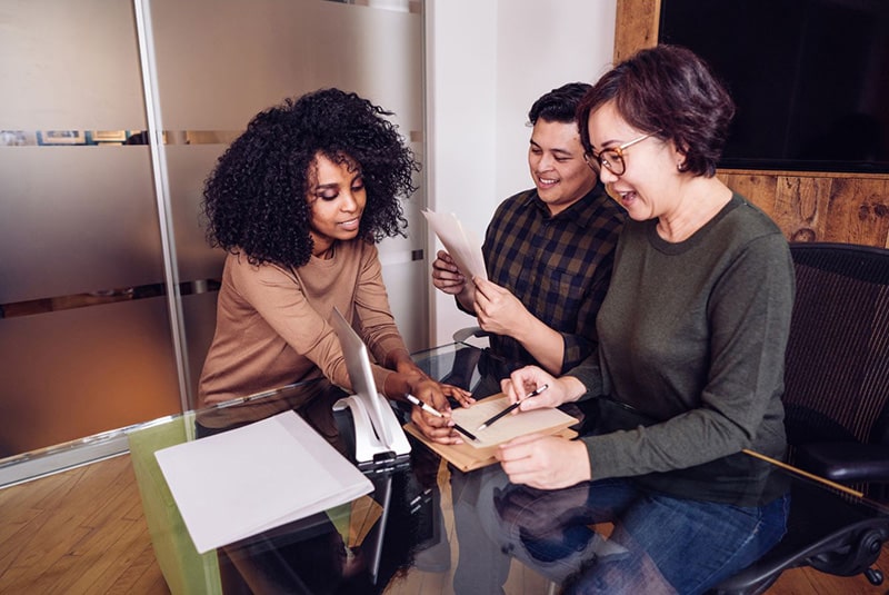 Employees collaborating at table