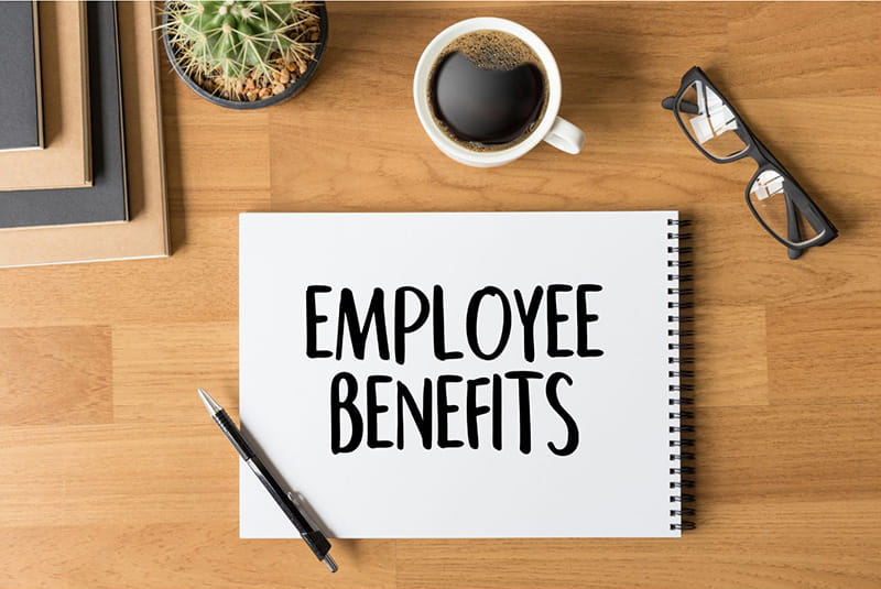 Employee Benefits written on notepad on desktop