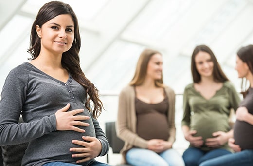 Group of pregnant women sitting down talking