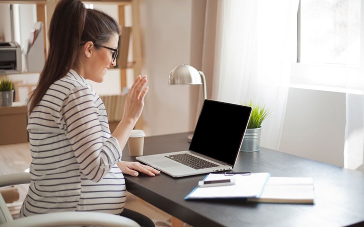Pregnant women working from home at desk